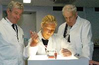 A set of images of Tariq Ashkanani and Clara Calvert showing two men, possibly named "Tam" and "Prin", a chemistry lab containing 3D glasses, a microscope, pipettes and unknown sample.  5 images.